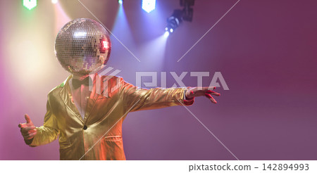 Disco mirrorball head performer in gold suit pointing on smoky party stage Disco mirrorball head performer in gold suit pointing on smoky party stage 142894993