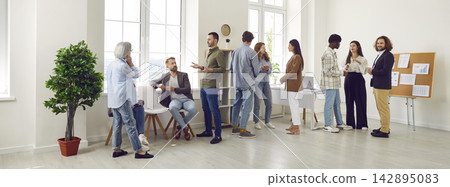 Team of Business People Engaged in Communication during Office Meeting Team of Business People Engaged in Communication during Office Meeting 142895083