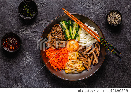 Bibimbap with colorful vegetables, beef, and egg Bibimbap with colorful vegetables, beef, and egg 142896259