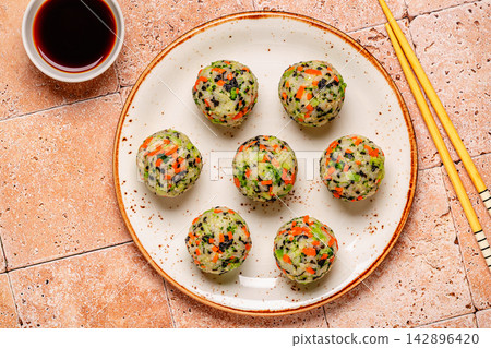 Korean rice balls (jumeokbap) with vegetables served with sauce Korean rice balls (jumeokbap) with vegetables served with sauce 142896420