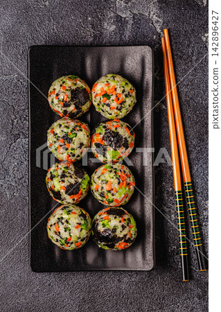 Korean rice balls (jumeokbap) with vegetables served with sauce Korean rice balls (jumeokbap) with vegetables served with sauce 142896427