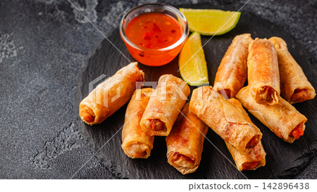 Fried spring rolls served with sauce and lime Fried spring rolls served with sauce and lime 142896438