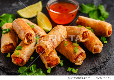 Fried spring rolls served with sauce and lime Fried spring rolls served with sauce and lime 142896439