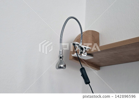 Adjustable LED Clip Lamp on Wooden Shelf for Modern Home or Office Lighting 142896596