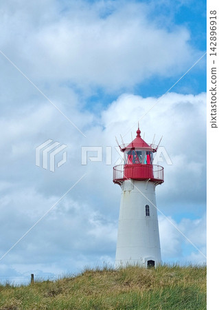 Majestic Lighthouse Against Blue Sky for Coastal Landscape Photography and Design Majestic Lighthouse Against Blue Sky for Coastal Landscape Photography and Design 142896918