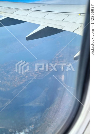 Aerial View from Airplane Window Over Coastal Landscape Aerial View from Airplane Window Over Coastal Landscape 142896957