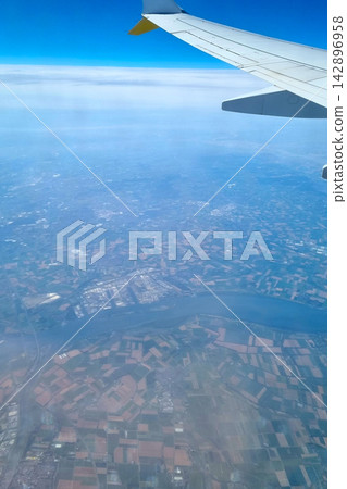 Aerial View of Landscape and River with Airplane Wing Travel and Adventure Concept Aerial View of Landscape and River with Airplane Wing Travel and Adventure Concept 142896958