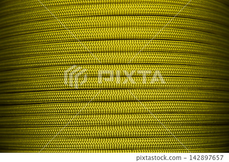 Close-up of yellow nylon paracord tightly spooled Close-up of yellow nylon paracord tightly spooled 142897657