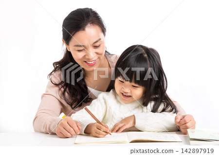 Asian Mother and Daughter Laughing Together While Studying Asian Mother and Daughter Laughing Together While Studying 142897919