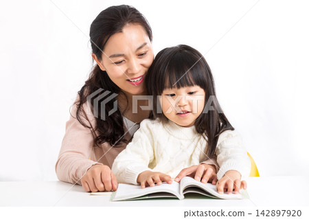 Asian Mother and Daughter Laughing Together While Studying Asian Mother and Daughter Laughing Together While Studying 142897920