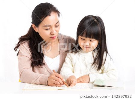 Asian Mother and Daughter Laughing Together While Studying 142897922
