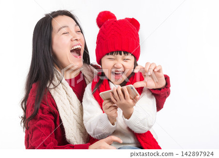 Asian Mother and Daughter Taking Selfie Together During Holiday 142897924