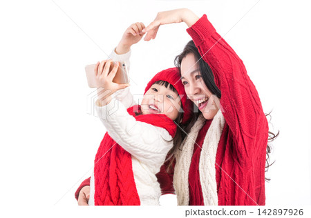 Asian Mother and Daughter Taking Selfie Together During Holiday 142897926