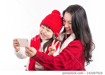 Asian Mother and Daughter Taking Selfie Together During Holiday Asian Mother and Daughter Taking Selfie Together During Holiday 142897928