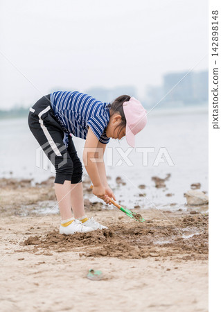 Children Playing with Sand and Water Tools on the Beach, Kids Exploring Muddy Shoreline, Sensory Play and Nature Discovery Children Playing with Sand and Water Tools on the Beach, Kids Exploring Muddy Shoreline, Sensory Play and Nature Discovery 142898148