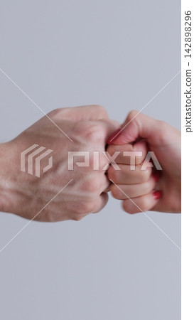 Vertical video. Fist to fist commit solidarity a respect gesture. Lifestyle business team hands fists close-up. Business concept of teamwork. Vertical video. Fist to fist commit solidarity a respect gesture. Lifestyle business team hands fists close-up. Business concept of teamwork. 142898296
