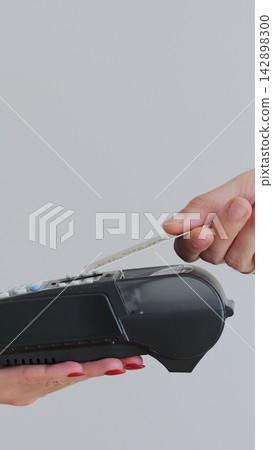 Vertical video. Close-up of unrecognizable man using credit card contactless payment. Modern technologies and restaurant business concept. Vertical video. Close-up of unrecognizable man using credit card contactless payment. Modern technologies and restaurant business concept. 142898300
