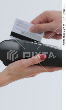 Vertical video. Credit card machine for money transaction. Man hand with credit card swipe through pos terminal. Banking services of electronic money. Financial success and safety. Vertical video. Credit card machine for money transaction. Man hand with credit card swipe through pos terminal. Banking services of electronic money. Financial success and safety. 142898302