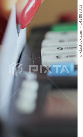 Vertical video. Credit card machine for money transaction. Close up of woman hand with credit card swipe through pos terminal and enter pin code. Banking services of electronic money. Financial Vertical video. Credit card machine for money transaction. Close up of woman hand with credit card swipe through pos terminal and enter pin code. Banking services of electronic money. Financial 142898312