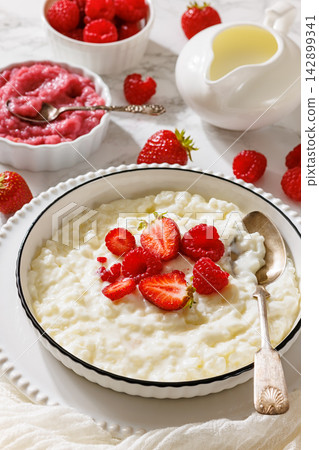 Milchreis german milk rice pudding with berries Milchreis german milk rice pudding with berries 142899341