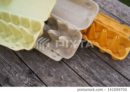 Top view of open cardboard egg boxes in different colors for handmade holiday decorations 142899700