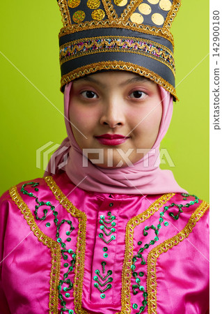 Portrait Of Young Indonesian Asian Girl In Traditional Pink Costume And Decorative Headpiece Wearing A Hijab Portrait Of Young Indonesian Asian Girl In Traditional Pink Costume And Decorative Headpiece Wearing A Hijab 142900180