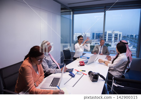 Middle Eastern business team in a corporate meeting at a modern startup office with diverse professionals Middle Eastern business team in a corporate meeting at a modern startup office with diverse professionals 142900315