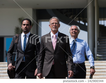 Middle Eastern business leaders walking confidently in modern corporate office for a startup meeting Middle Eastern business leaders walking confidently in modern corporate office for a startup meeting 142900344