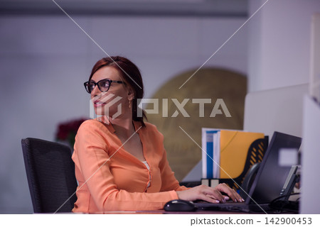 Middle Eastern woman professional working at office computer in modern startup workspace during meeting Middle Eastern woman professional working at office computer in modern startup workspace during meeting 142900453