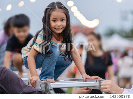 preschool child girl climbing step ladder in park preschool child girl climbing step ladder in park 142900578