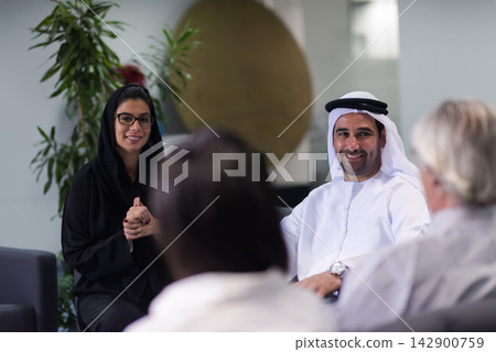 Middle Eastern business people collaborating in a modern office during a friendly corporate meeting 142900759