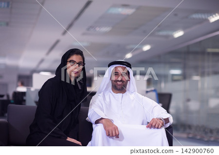Middle Eastern business colleagues in a modern open office smiling during a relaxed corporate meeting Middle Eastern business colleagues in a modern open office smiling during a relaxed corporate meeting 142900760