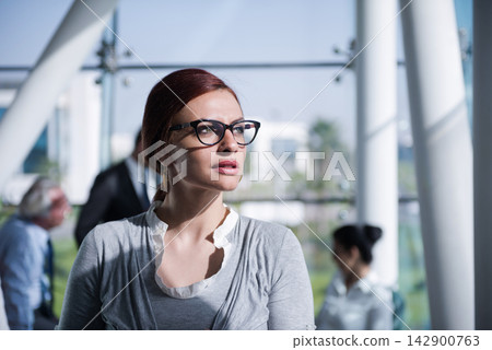 Middle Eastern businesswoman in modern office during a corporate meeting showing confident leadership and focus Middle Eastern businesswoman in modern office during a corporate meeting showing confident leadership and focus 142900763