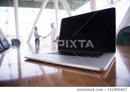 Middle Eastern business meeting in modern open office with laptop and handshake in boardroom Middle Eastern business meeting in modern open office with laptop and handshake in boardroom 142900807