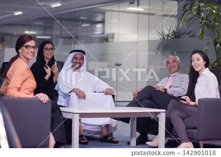 Middle Eastern business team meeting in a modern open office with diverse professionals and collaborative atmosphere Middle Eastern business team meeting in a modern open office with diverse professionals and collaborative atmosphere 142901018