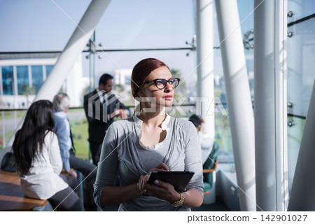 Middle Eastern businesswoman using tablet in modern startup office during a corporate meeting and planning session Middle Eastern businesswoman using tablet in modern startup office during a corporate meeting and planning session 142901027