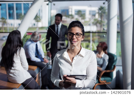 Middle Eastern businesswoman leading a meeting in a modern open-space corporate startup office Middle Eastern businesswoman leading a meeting in a modern open-space corporate startup office 142901076