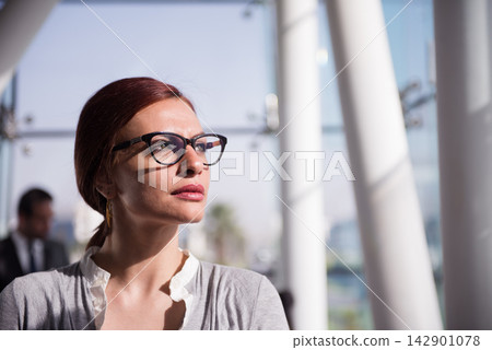 Middle Eastern businesswoman in modern office looking thoughtful during a startup meeting in open workspace Middle Eastern businesswoman in modern office looking thoughtful during a startup meeting in open workspace 142901078