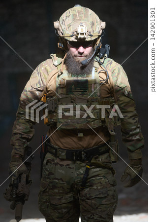Bearded Soldier Wearing Camouflage Tactical Gear And Helmet Holding Rifle During Urban Operation Bearded Soldier Wearing Camouflage Tactical Gear And Helmet Holding Rifle During Urban Operation 142901301