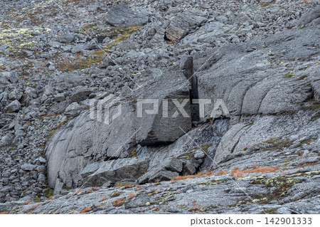 Tectonic fault line and rockfall hazard zone with cracked mountain granite boulder Tectonic fault line and rockfall hazard zone with cracked mountain granite boulder 142901333