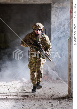 Tactical Soldier Running With Rifle in Urban Combat Training Amid Smoke and Ruins 142901367