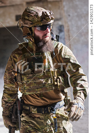 Bearded Soldier In Tactical Military Gear With Helmet And Rifle During Urban Operation Bearded Soldier In Tactical Military Gear With Helmet And Rifle During Urban Operation 142901373