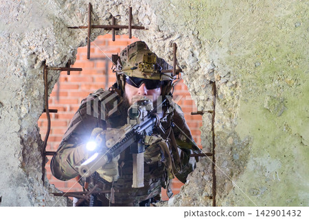 Tactical Soldier With Rifle Aiming Through Rubble In Urban Combat Training Scenario Tactical Soldier With Rifle Aiming Through Rubble In Urban Combat Training Scenario 142901432