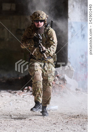 Armed Soldier in Tactical Camouflage Running Through Urban Ruins With Rifle During Military Exercise Armed Soldier in Tactical Camouflage Running Through Urban Ruins With Rifle During Military Exercise 142901440