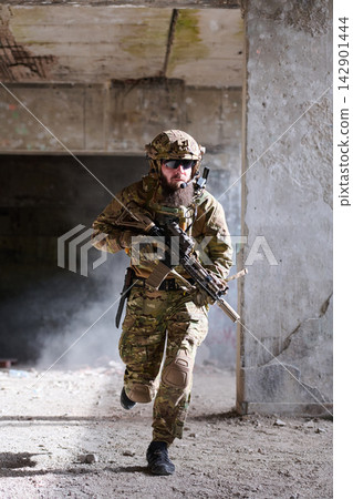 Soldier in Tactical Gear Running With Rifle Inside Abandoned Building During Urban Combat Training Soldier in Tactical Gear Running With Rifle Inside Abandoned Building During Urban Combat Training 142901444