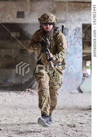 Tactical Soldier in Camouflage Gear Running With Rifle Through Abandoned Urban Building During Training Exercise Tactical Soldier in Camouflage Gear Running With Rifle Through Abandoned Urban Building During Training Exercise 142901445