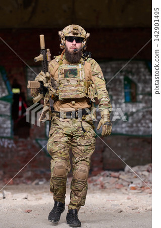 Tactical Soldier in Camouflage Gear Holding Rifle During Urban Patrol in Abandoned Building Tactical Soldier in Camouflage Gear Holding Rifle During Urban Patrol in Abandoned Building 142901495
