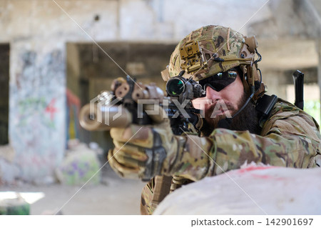 Tactical Soldier Aiming Scoped Rifle During Urban Combat Training Exercise In Camouflage Gear Tactical Soldier Aiming Scoped Rifle During Urban Combat Training Exercise In Camouflage Gear 142901697