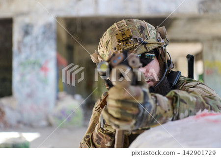 Tactical Soldier Aiming Rifle in Urban Combat Training With Helmet Night Vision and Camouflage Gear Tactical Soldier Aiming Rifle in Urban Combat Training With Helmet Night Vision and Camouflage Gear 142901729