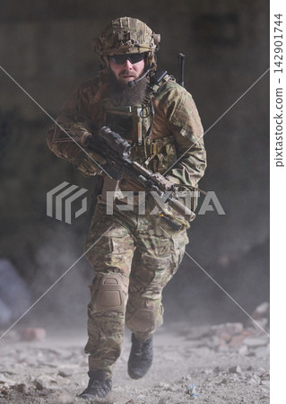 Armed Soldier in Camouflage Tactical Gear Running With Rifle During Urban Combat Operation Armed Soldier in Camouflage Tactical Gear Running With Rifle During Urban Combat Operation 142901744